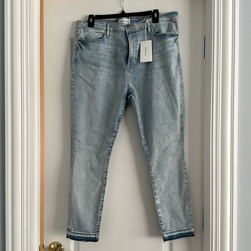 Frame Denim distressed wash with raw edge leg